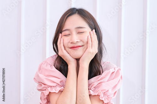 Funny and joyful Asian girl smile on white background