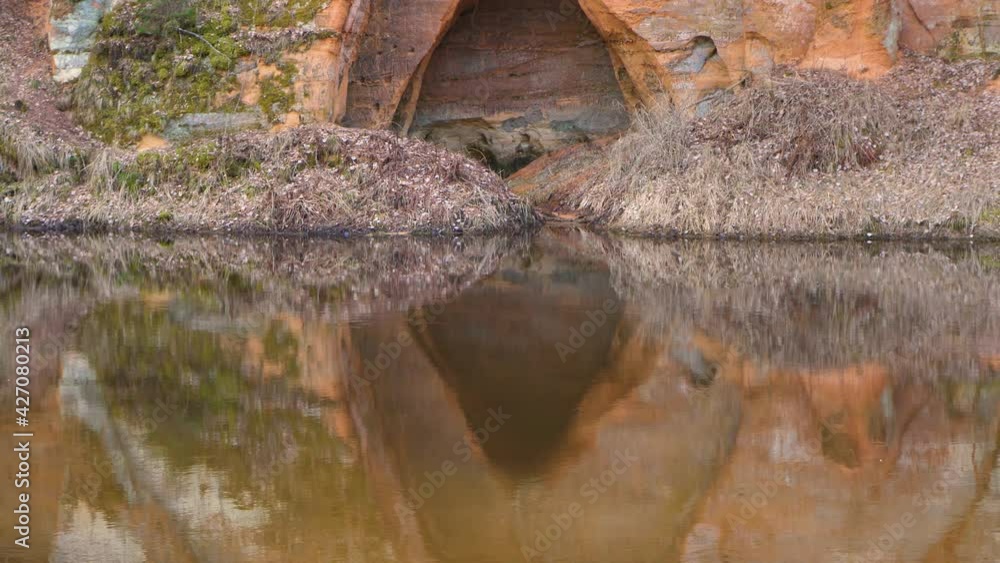 A nature-created angelic cave on the river bank. Protected rock by the river. Sandy rocks by the river. Sand rock a few meters high A nature-created angelic cave on the river bank. Protected rock by the river. Sandy rocks by the river. Sand rock a few meters high