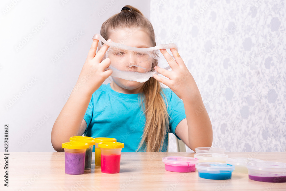 The blonde-haired child is playing with mucus. Little beautiful caucasian girl is playing with many slugs. Play Slime Toy The blonde-haired child is playing with mucus. Little beautiful caucasian girl is playing with many slugs. Play Slime Toy