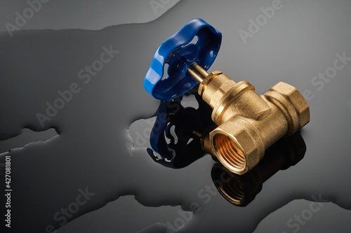 plumbing water ball valve is used to stop the supply of water or gas to the pipeline on dark background photo