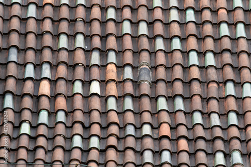 Tile roof texture. Tiled acute-angled cross-slab. Roof tiles made from fired clay