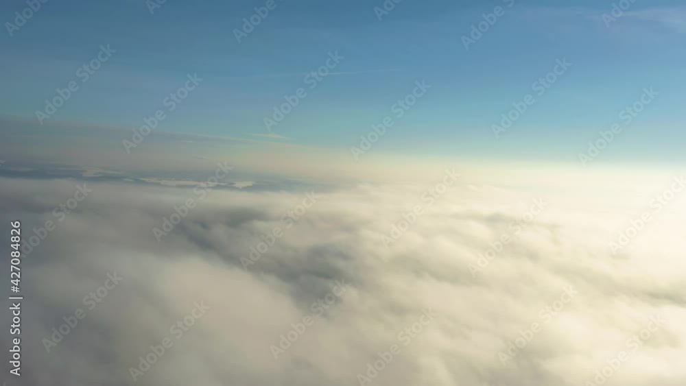 Amazing aerial shot of clouds in the sky. Drone flying over the clouds. Cinematic of sun shining above the clouds.
Amazing aerial shot of clouds in the sky. Drone flying over the clouds. Cinematic of sun shining above the clouds.