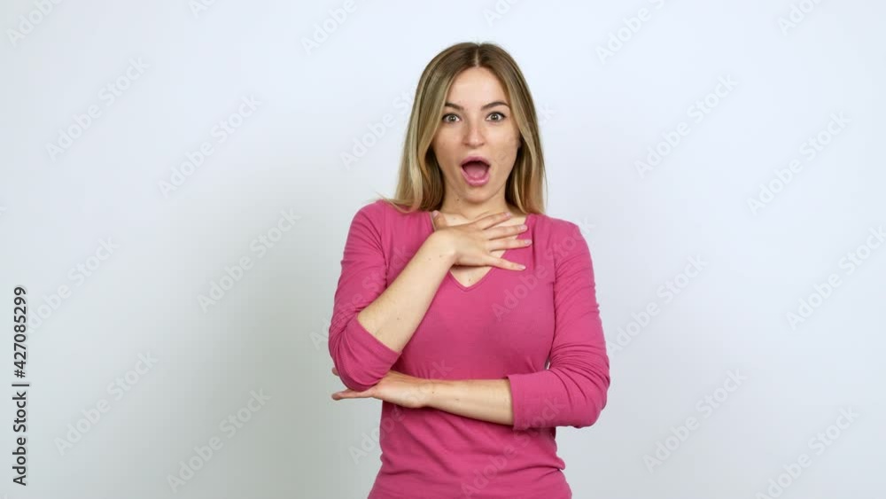 Young woman gaping because have just surprised with a gift over isolated background Young woman gaping because have just surprised with a gift over isolated background