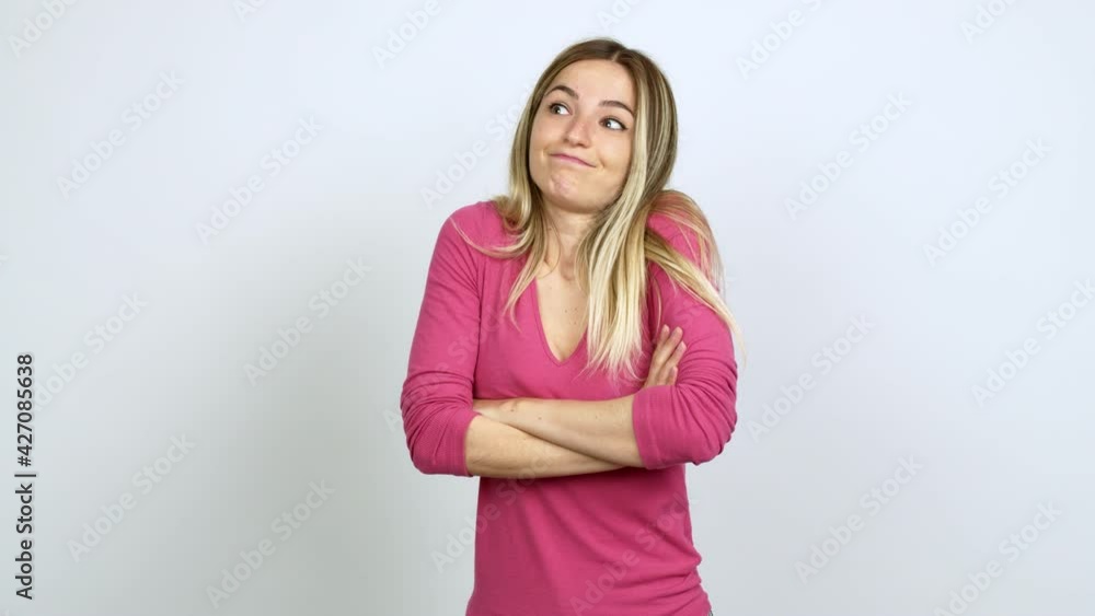 Young woman making unimportant and doubts gesture while lifting the shoulders and the palms of the hands over isolated background Young woman making unimportant and doubts gesture while lifting the shoulders and the palms of the hands over isolated background