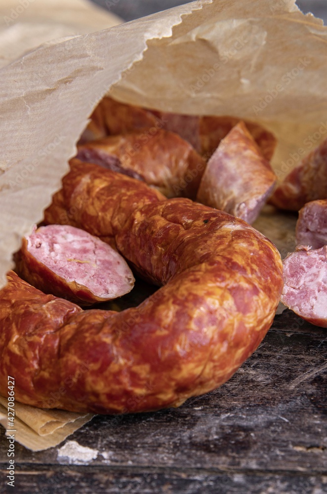 Coiled cumberland sausage with garlic rustic board Coiled cumberland sausage with garlic rustic board