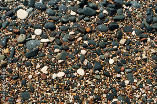 wet multi colored stones and pebbles on sea beach 