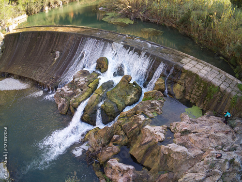 drone view of the reservoir and waterfall on the Serpis greenway in Alcoy, located in Alicante, Spain photo