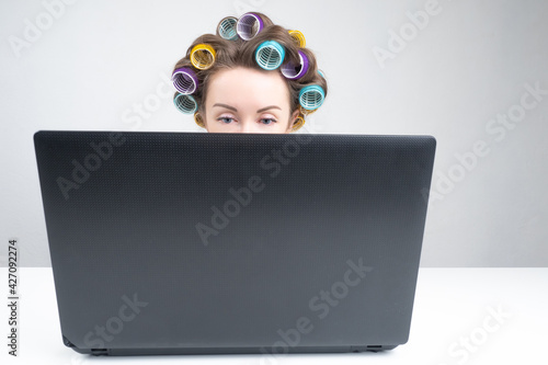 Woman in curlers works with...