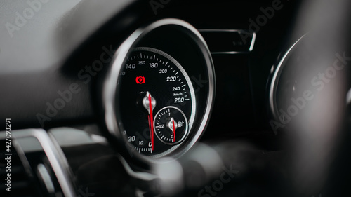 Modern car speedometer close up. Dashboard with speedometer, tachometer, odometer.
