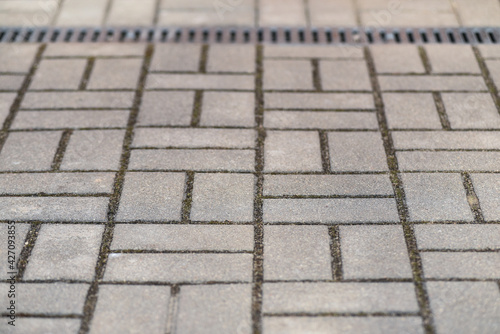 Walkway surface design. Fragment of the square, lined with large concrete tiles. Selective focus.