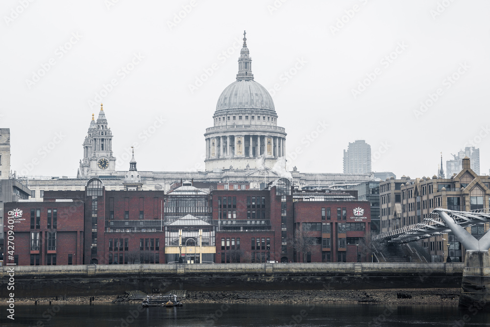 City of London and St. Pauls cathedral in raining, misty day view from the River Thames. Empty streets of London during national lockdown UK, 2021