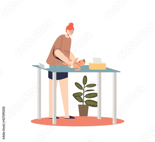 Mother changing diaper to newborn kid on diaper table. Young female taking care of infant baby
