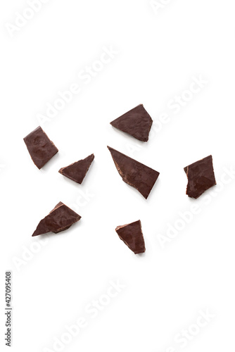 Top view of dark chocolate pieces isolated on white background