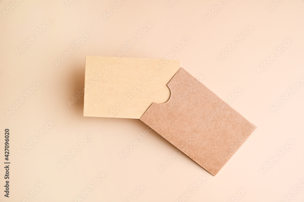 Stylish branding mockup for displaying your artwork, business cards on craft paper. Recyclable material concept, eco-friendly manufacturing. Flat top view. High quality photo Stylish branding mockup for displaying your artwork, business cards on craft paper. Recyclable material concept, eco-friendly manufacturing. Flat top view. High quality photo