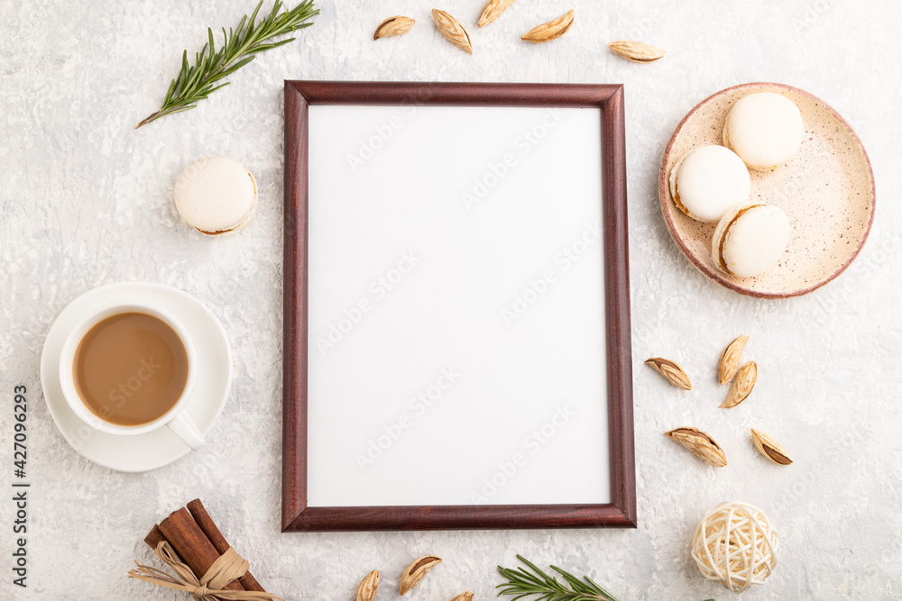 Brown wooden frame mockup with cup of coffee, almonds and macaroons on gray concrete background. top view Brown wooden frame mockup with cup of coffee, almonds and macaroons on gray concrete background. top view