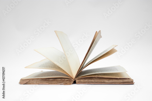 Antique open book isolated with flipping pages on white background