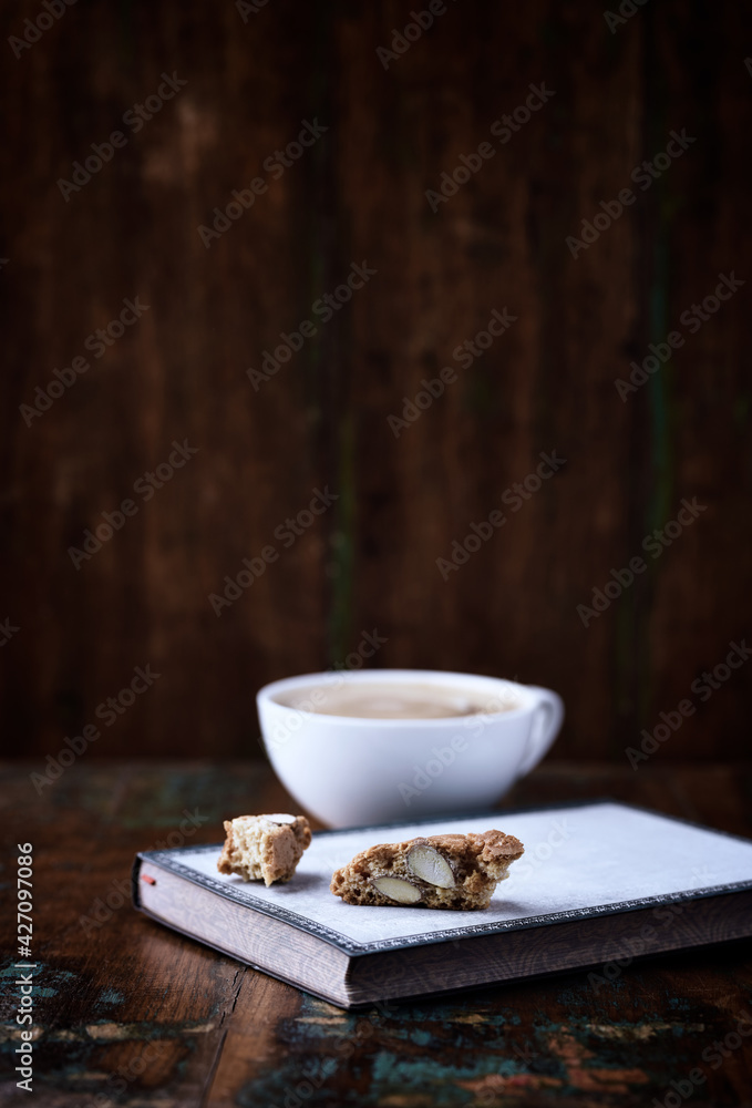 Cantuccini (Italian cookie) and Cappuccino on dark wooden background. Copy space. Cantuccini (Italian cookie) and Cappuccino on dark wooden background. Copy space.