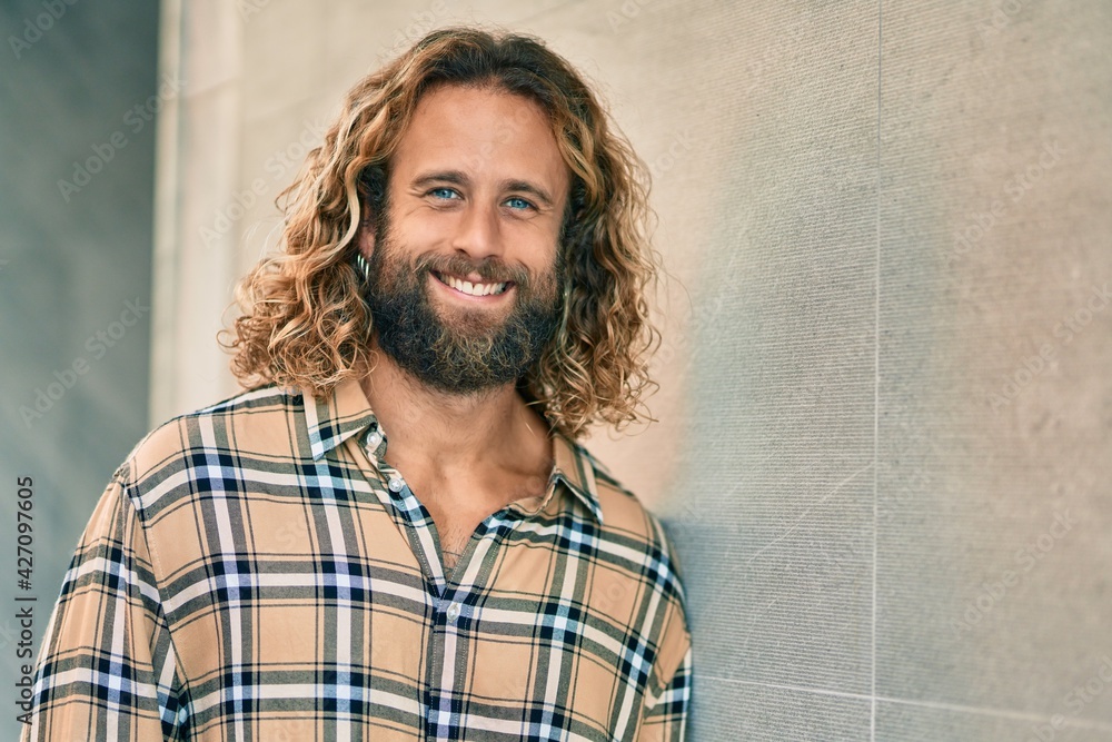 Young caucasian man smiling happy at the city. Young caucasian man smiling happy at the city.