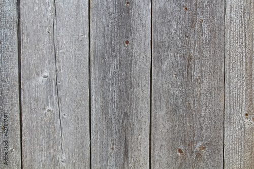 The wall of the building is made of old planks.