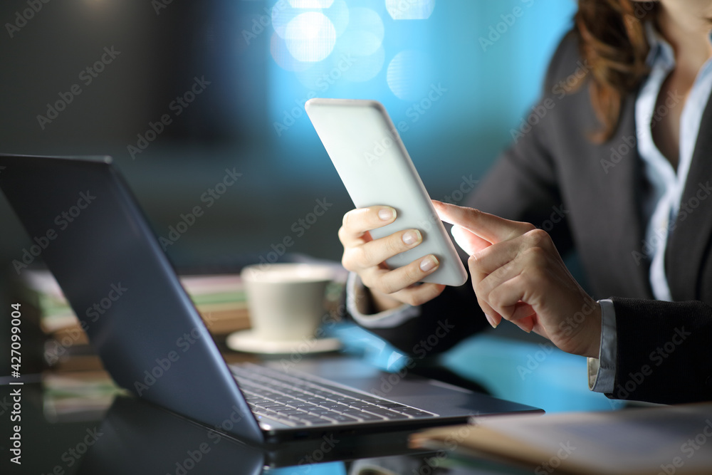 Self employed hands using phone and laptop in the night Self employed hands using phone and laptop in the night