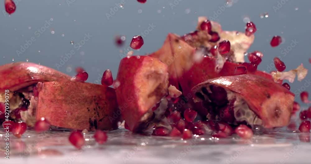 SUPER SLOW MOTION Shot of pomergranate falling to pieces on the table. Shot on high speed camera at 720 FPS SUPER SLOW MOTION Shot of pomergranate falling to pieces on the table. Shot on high speed camera at 720 FPS