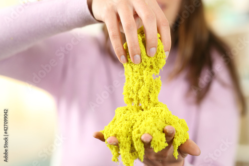 Woman hands playing with magic sand at home photo