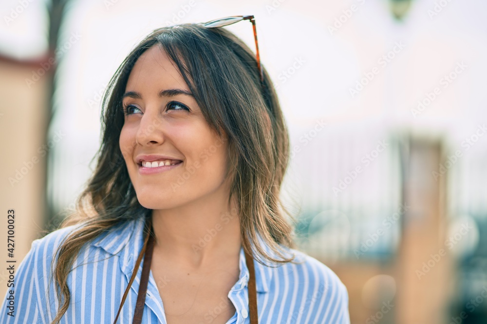 Young hispanic woman smiling happy standing at the city. Young hispanic woman smiling happy standing at the city.