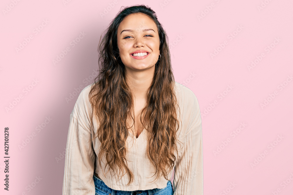 Young hispanic girl wearing casual clothes with a happy and cool smile on face. lucky person. Young hispanic girl wearing casual clothes with a happy and cool smile on face. lucky person.