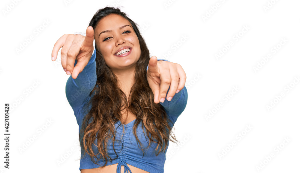Young hispanic girl wearing casual clothes pointing to you and the camera with fingers, smiling positive and cheerful Young hispanic girl wearing casual clothes pointing to you and the camera with fingers, smiling positive and cheerful