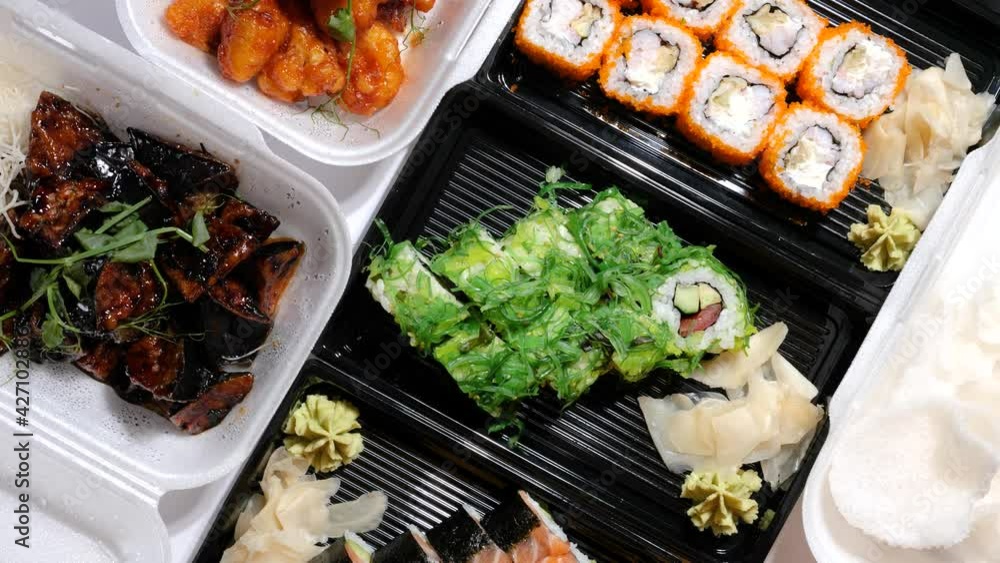 Assorted Asian, Chinese, Thai and Vietnamese food, sushi set, rolls, noodles, seafood, vegetables, shrimps chips take away container boxes, package lunch to go. Top view flat lay. Healthy balanced die Assorted Asian, Chinese, Thai and Vietnamese food, sushi set, rolls, noodles, seafood, vegetables, shrimps chips take away container boxes, package lunch to go. Top view flat lay. Healthy balanced die