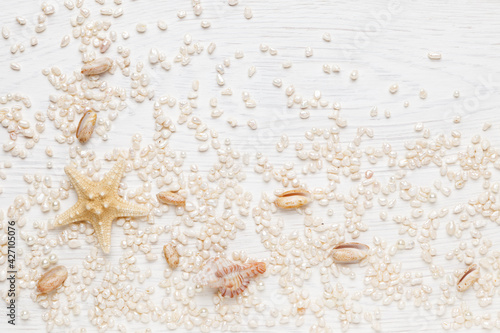 Seashells and pearls on a white background. Flat lay, Top view