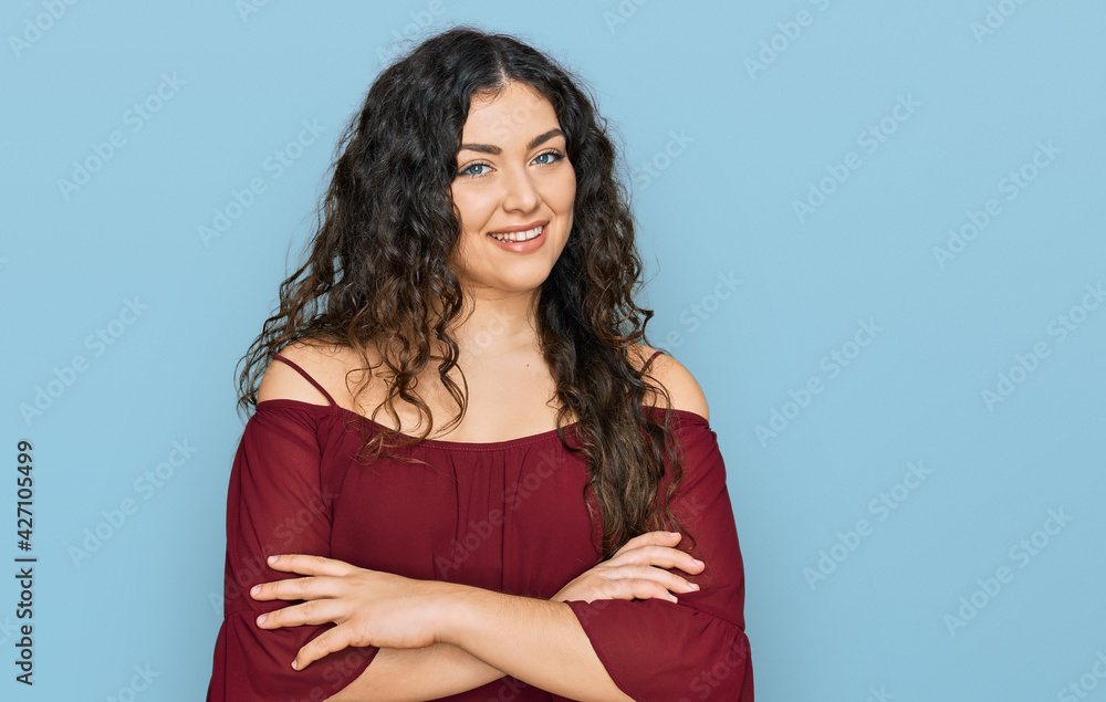 Fototapeta premium Young hispanic girl wearing casual clothes happy face smiling with crossed arms looking at the camera. positive person.