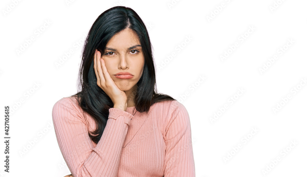 Young hispanic woman wearing casual clothes thinking looking tired and bored with depression problems with crossed arms. Young hispanic woman wearing casual clothes thinking looking tired and bored with depression problems with crossed arms.