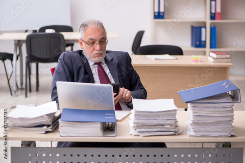 Aged male employee and too much work at workplace