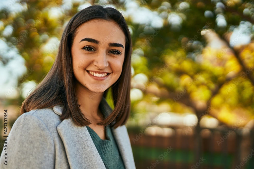 Young hispanic girl smiling happy standing at the park. Young hispanic girl smiling happy standing at the park.
