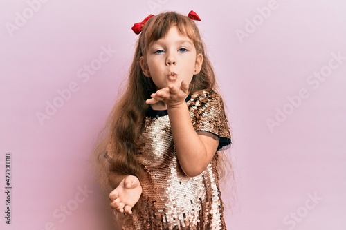Canvas-taulu Little caucasian girl kid wearing festive sequins dress looking at the camera blowing a kiss with hand on air being lovely and sexy