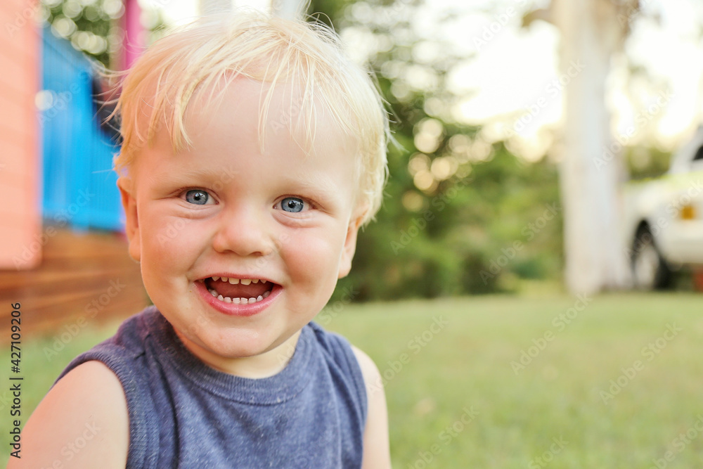 Toddler boy with big smile outdoors with nature background Toddler boy with big smile outdoors with nature background