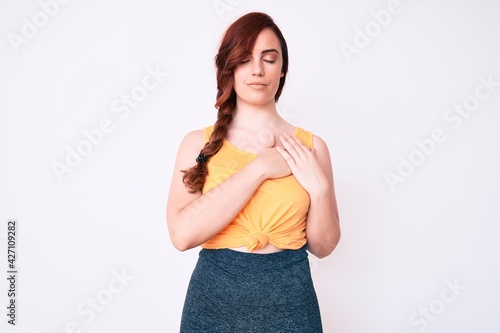 Young beautiful woman wearing casual clothes smiling with hands on chest, eyes closed with grateful gesture on face. health concept.