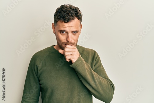 Young hispanic man wearing casual clothes feeling unwell and coughing as symptom for cold or bronchitis. health care concept. © Krakenimages.com