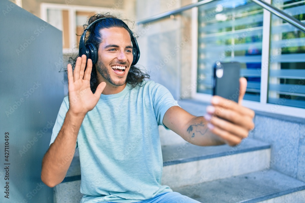 Young hispanic man smiling happy doing smartphone video call at city. Young hispanic man smiling happy doing smartphone video call at city.