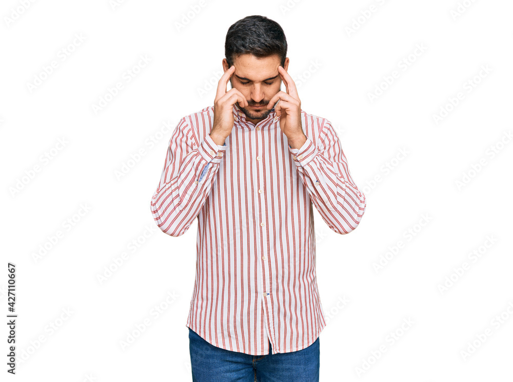 Young hispanic man wearing business shirt with hand on head for pain in head because stress. suffering migraine. Young hispanic man wearing business shirt with hand on head for pain in head because stress. suffering migraine.