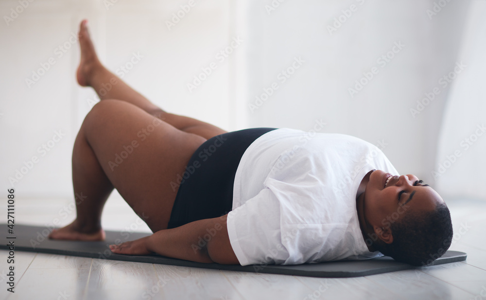 beautiful plus size woman exercising on sport mat at home beautiful plus size woman exercising on sport mat at home