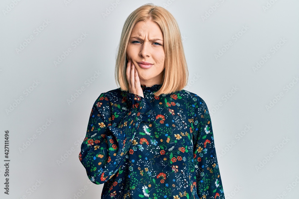 Young blonde woman wearing casual clothes touching mouth with hand with painful expression because of toothache or dental illness on teeth. dentist Young blonde woman wearing casual clothes touching mouth with hand with painful expression because of toothache or dental illness on teeth. dentist