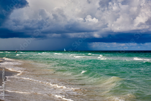 Cuba. Varadero. Beach in the morning. Sail on the background of rain clouds