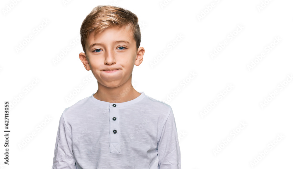 Little caucasian boy kid wearing casual clothes puffing cheeks with funny face. mouth inflated with air, crazy expression. Little caucasian boy kid wearing casual clothes puffing cheeks with funny face. mouth inflated with air, crazy expression.