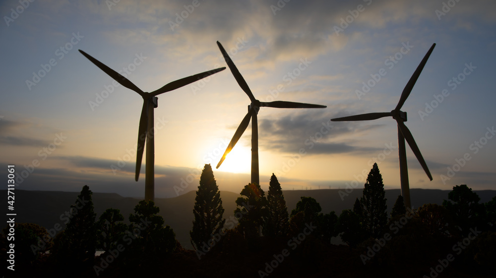 concept idea eco power energy. wind turbine on hill with sunset. Wind Turbine producing alternative energy. concept idea eco power energy. wind turbine on hill with sunset. Wind Turbine producing alternative energy.