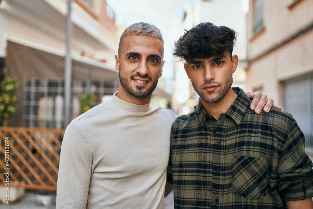Young gay couple smiling happy and hugging at the city. Young gay couple smiling happy and hugging at the city.