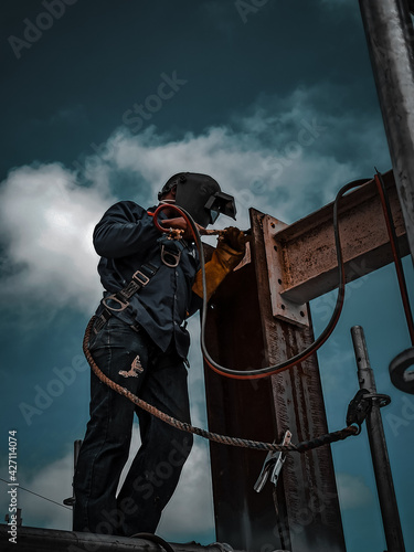 welder working on the installation and assembly of a metal structure