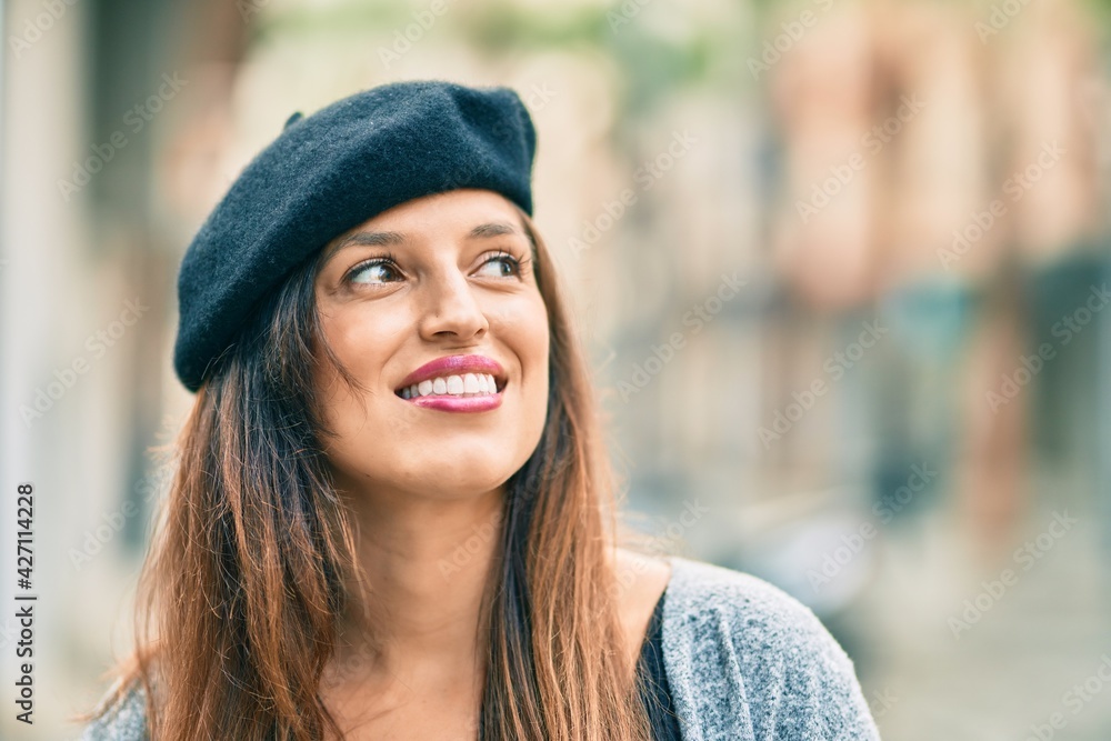 Young latin woman wearing french style standing at the city. Young latin woman wearing french style standing at the city.