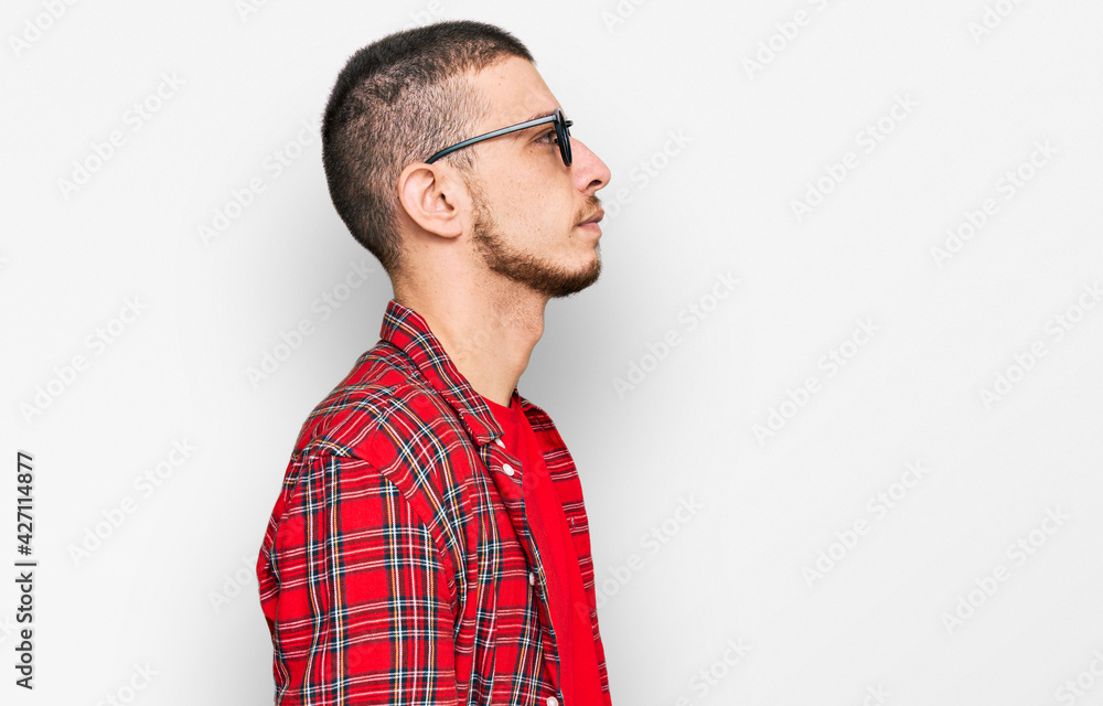 Hispanic young man wearing casual clothes looking to side, relax profile pose with natural face and confident smile. Hispanic young man wearing casual clothes looking to side, relax profile pose with natural face and confident smile.